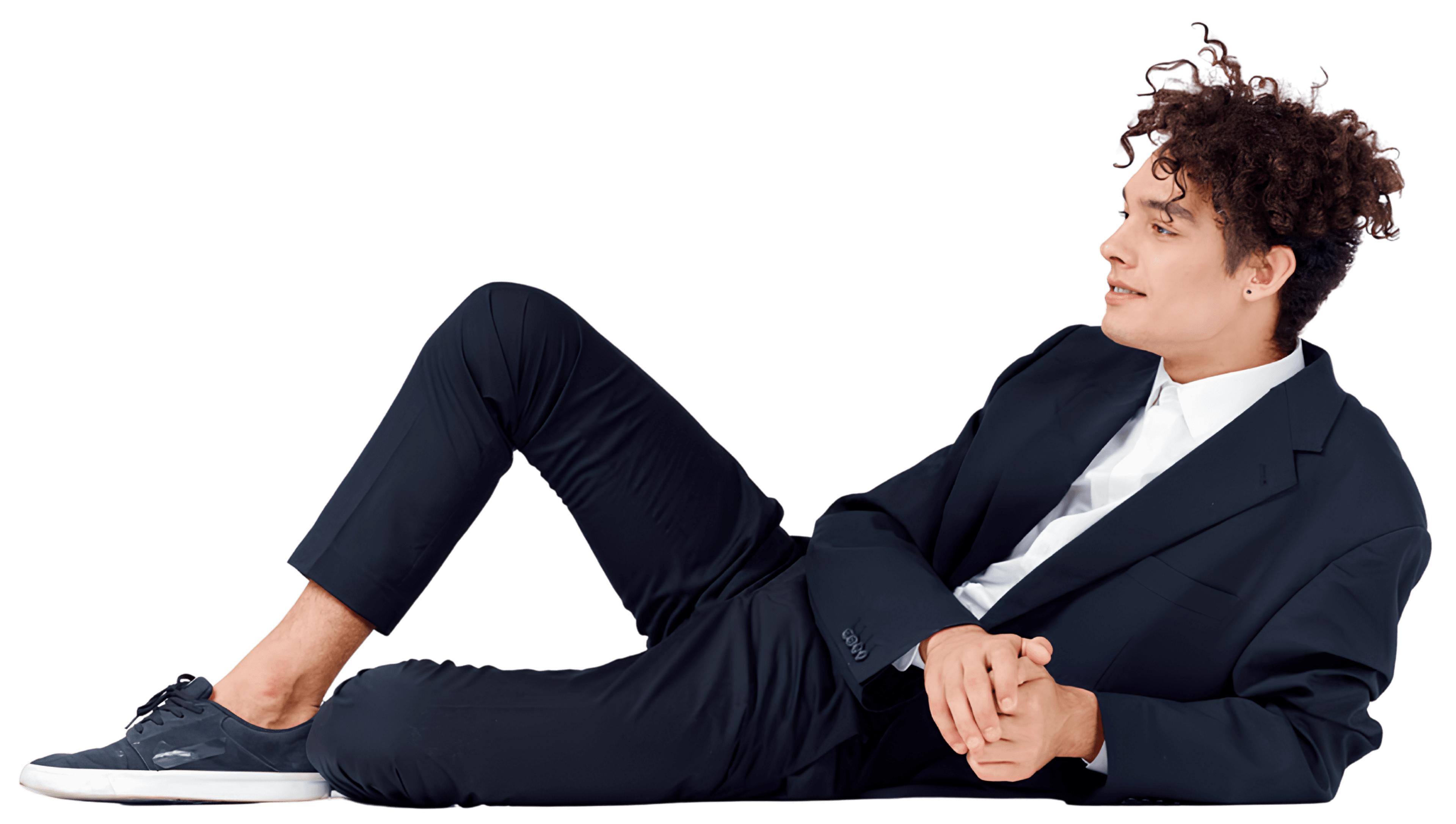 A person in a suit, reclining thoughtfully